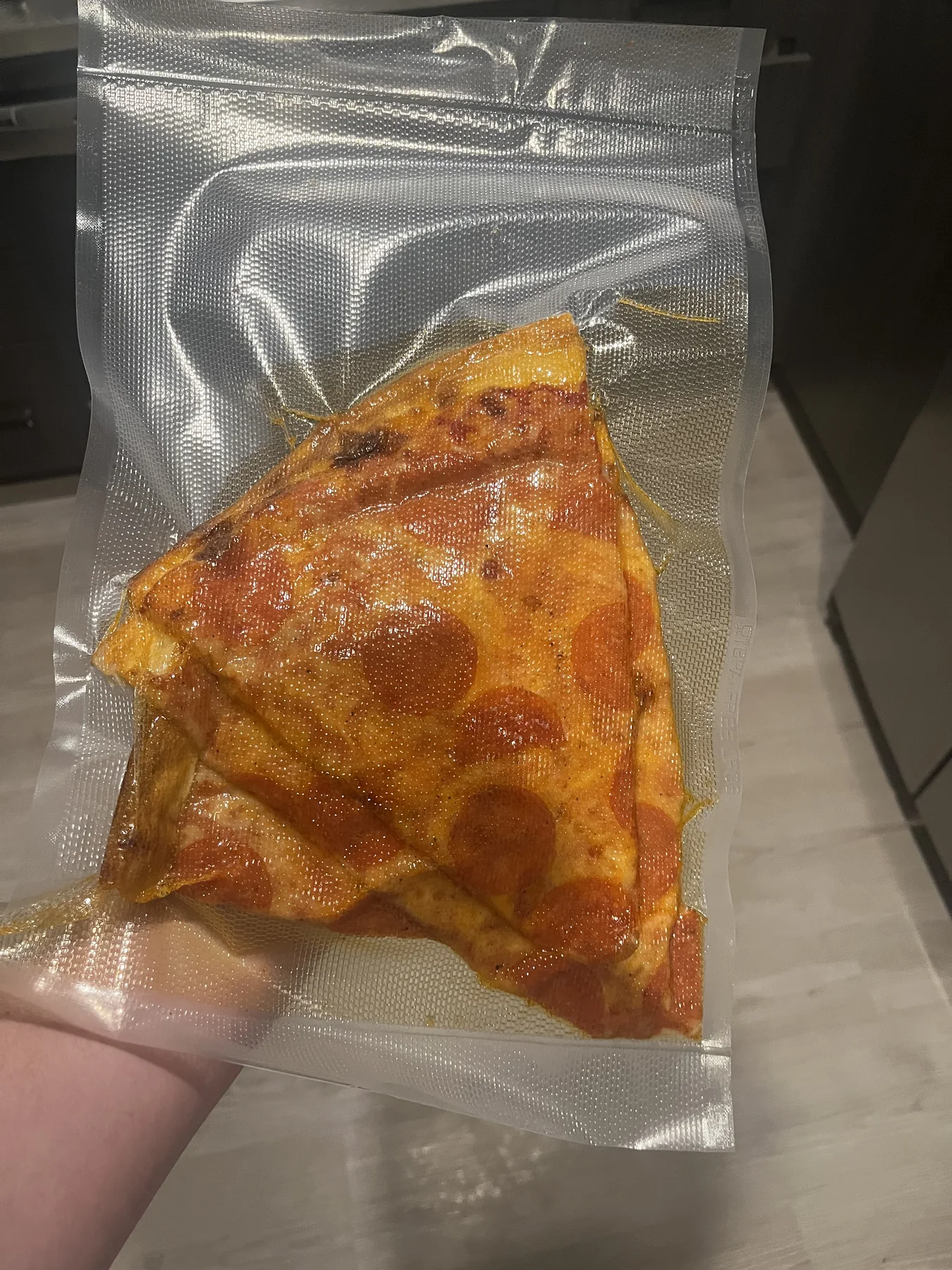 A slice of pizza vacuum-sealed while testing a new vacuum sealer