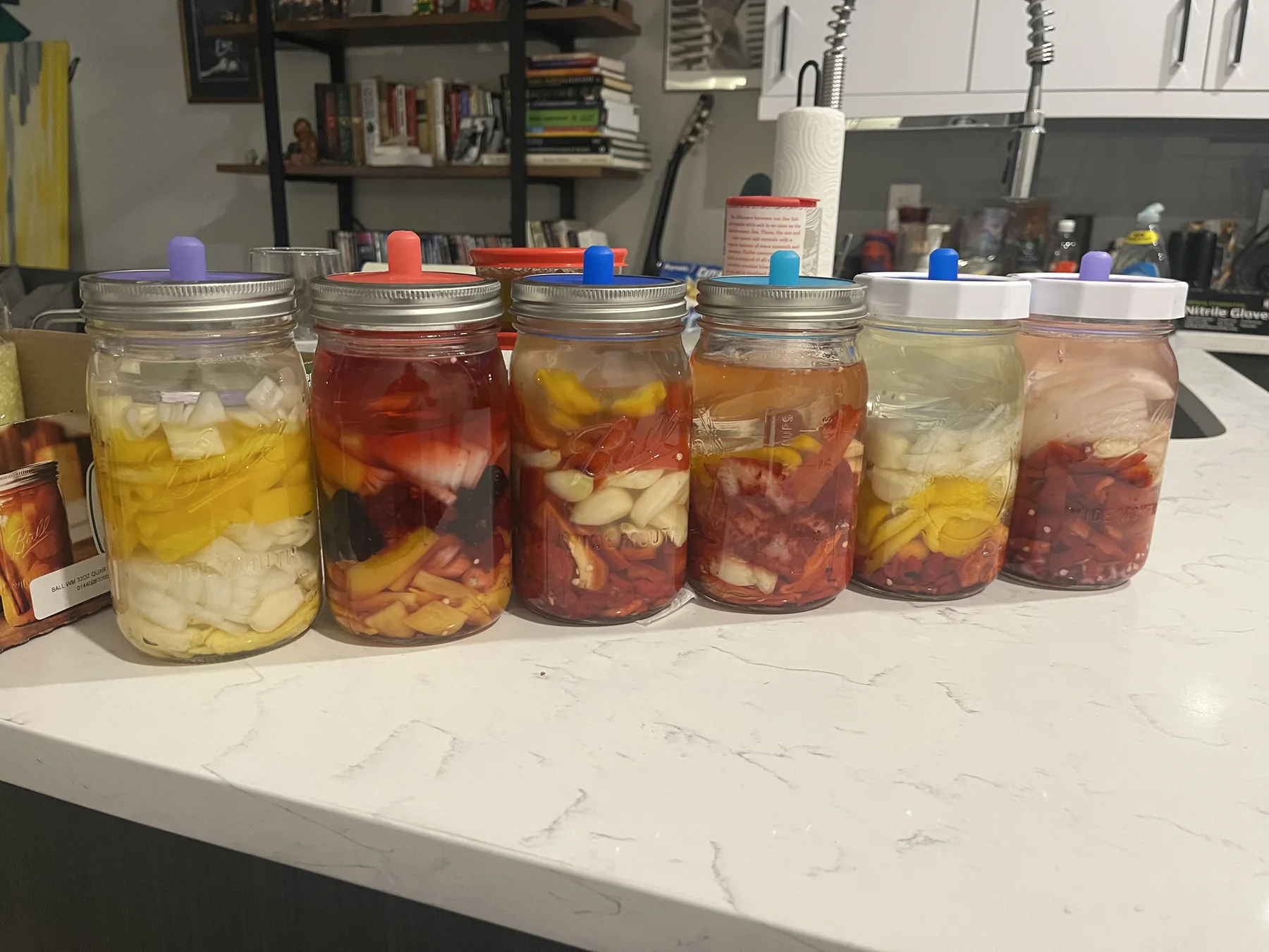 Homemade hot sauce ingredients fermenting in jars
