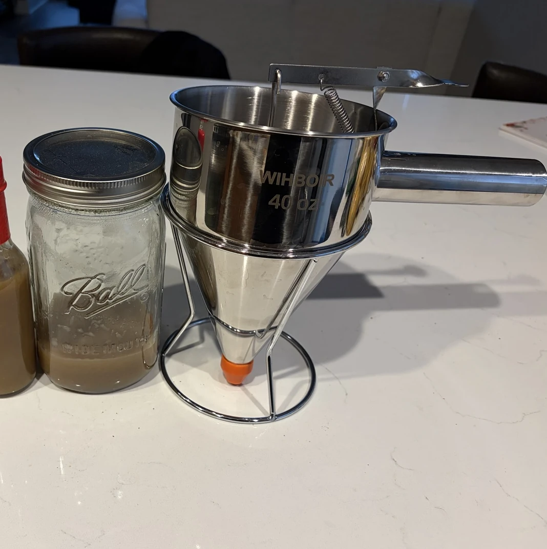 Pancake batter dispenser used to fill homemade hot sauce bottles