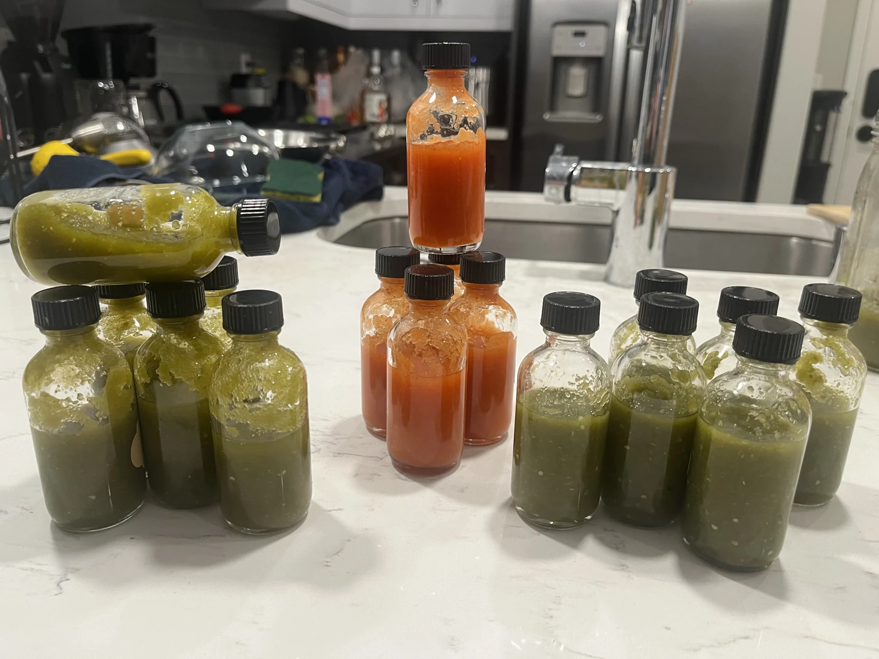 Small 2 ounce potion-style bottles filled with homemade hot sauce